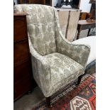 A 19th century wing armchair upholstered in patterned green floral fabric, width 68cm, depth 75cm,