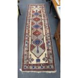 A Hamadan ivory ground runner with concentric medallion field, 320 x 96cm