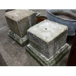 A near pair of carved stone plinths on bases, larger width 59cm, height 58cm
