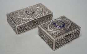 Two early 20th century Indian embossed white metal rectangular boxes, both with applied enamelled
