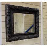 A late 17th century and later rectangular carved oak wall mirror with pierced scrolling acanthus