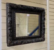 A late 17th century and later rectangular carved oak wall mirror with pierced scrolling acanthus