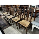 A set of ten George III style provincial oak rush seat dining chairs, two with arms.