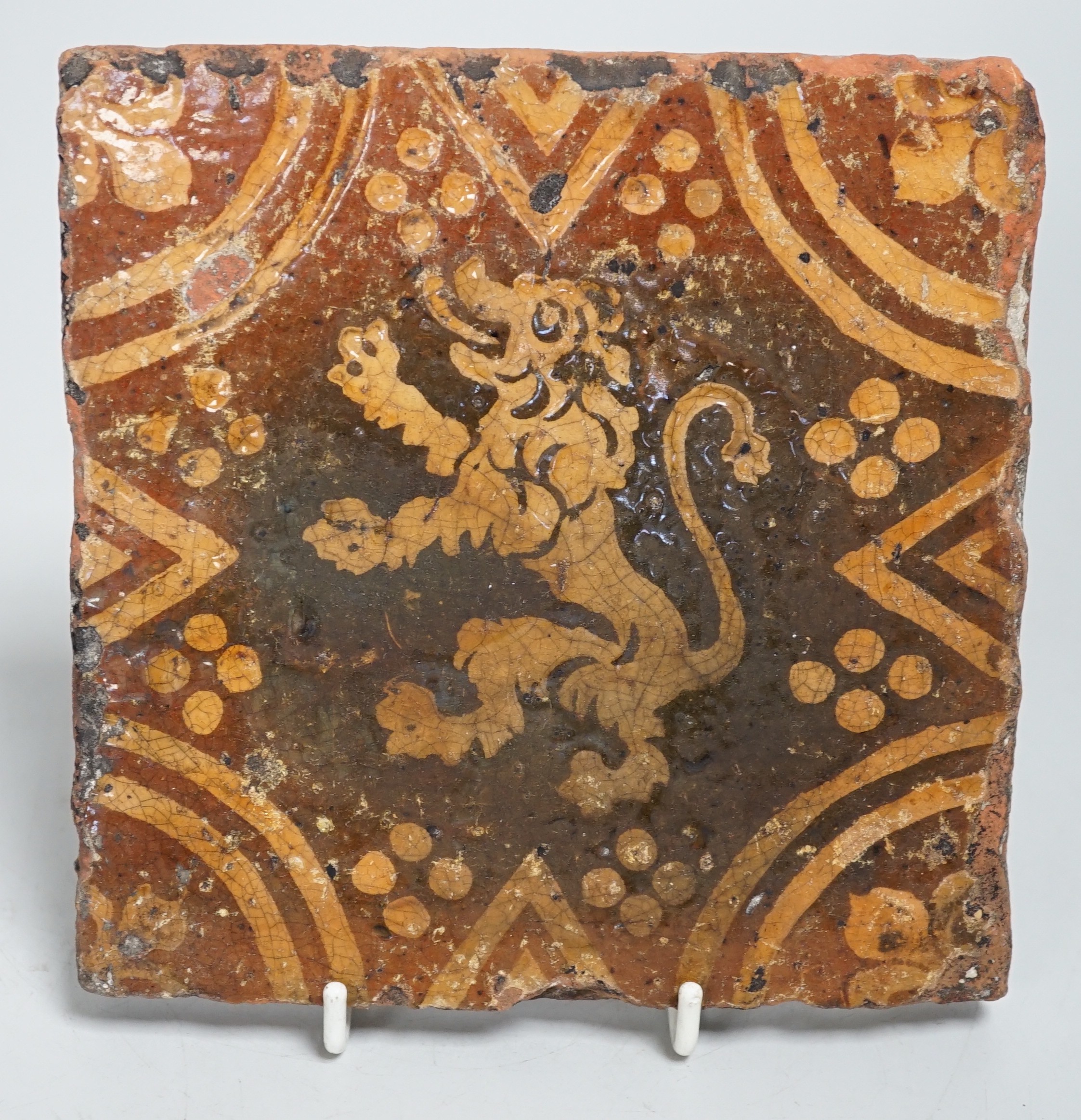 A single early ecclesiastical floor tile with rampant lion detail. 14 x 14cm