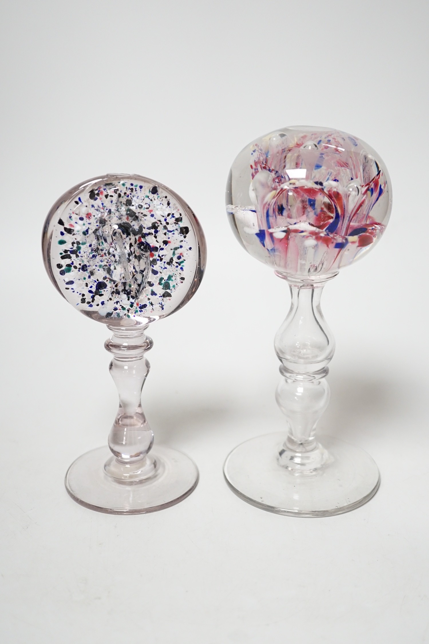 Two 19th century glass pedestal ornaments, one possibly a wig stand, the other containing a sulphide