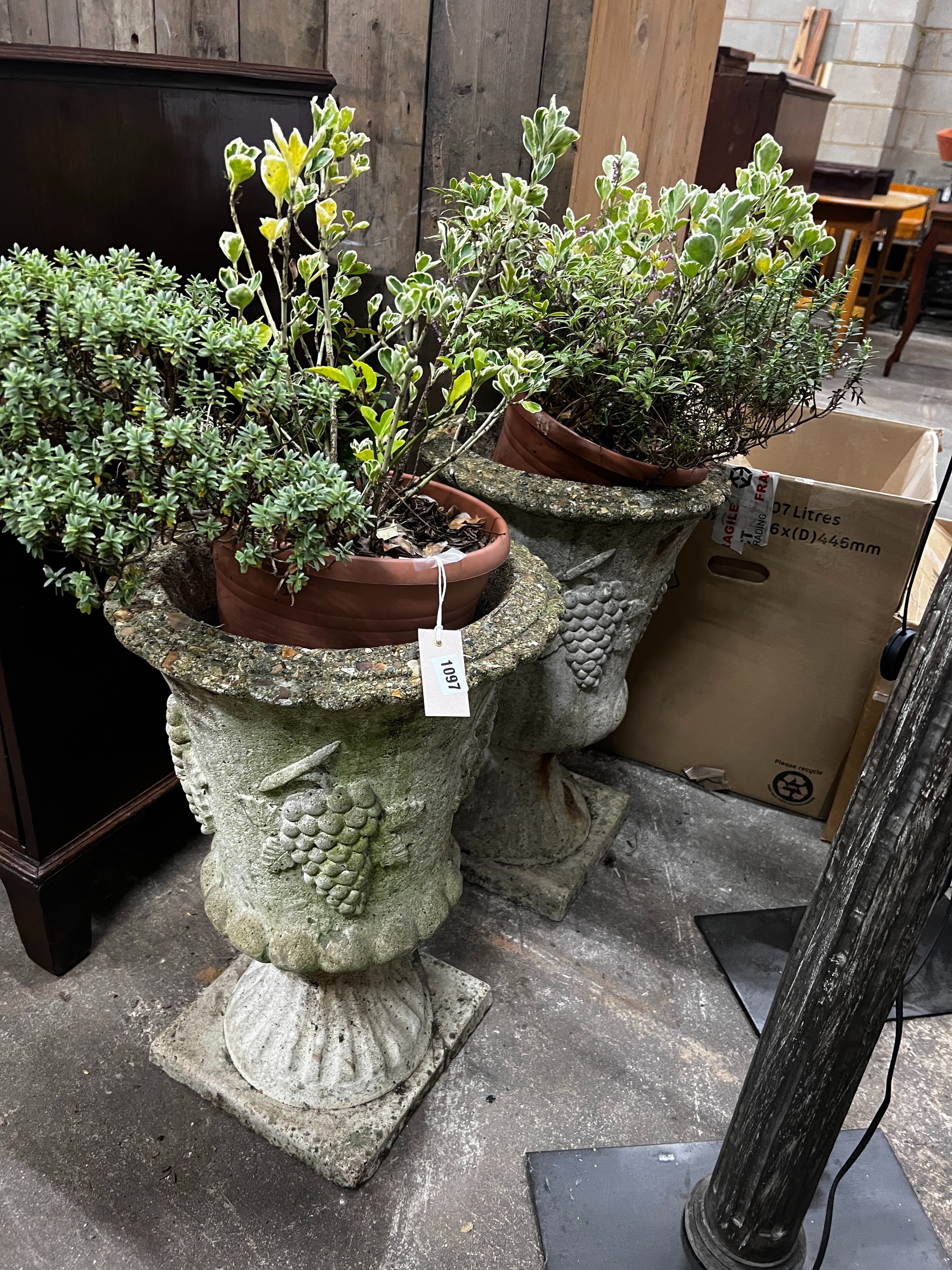 A pair of reconstituted stone circular garden planters, diameter 36cm, height 60cm