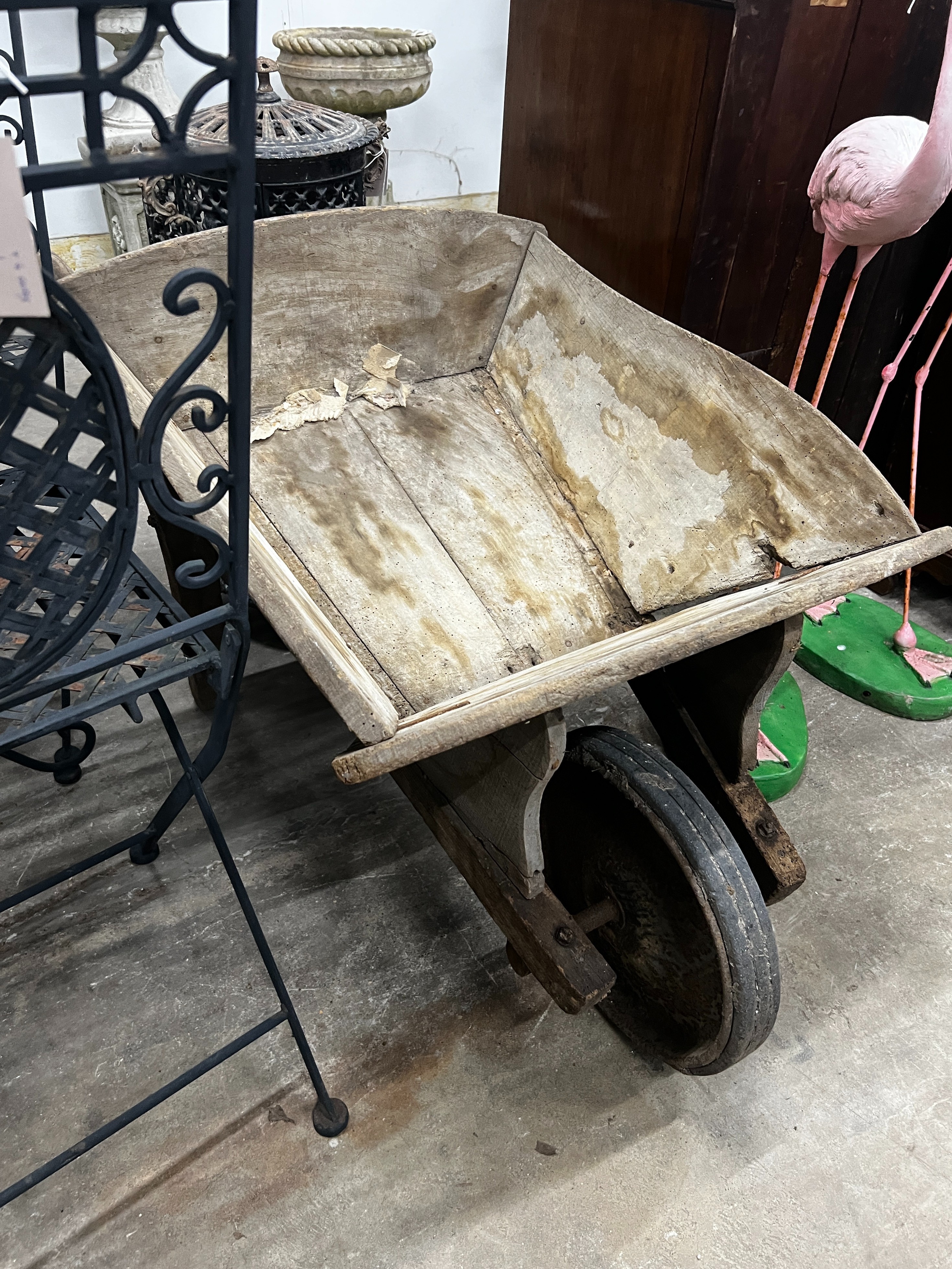 A rustic wooden wheelbarrow, width 60cm, length 110cm, height 53cm