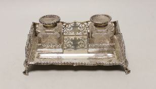 A George V pierced silver rectangular inkstand, with two mounted glass bottles and pen recess,