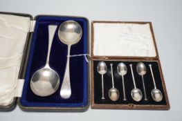 A set of six George V silver seal top coffee spoon, cased, and a pair of George V silver old English