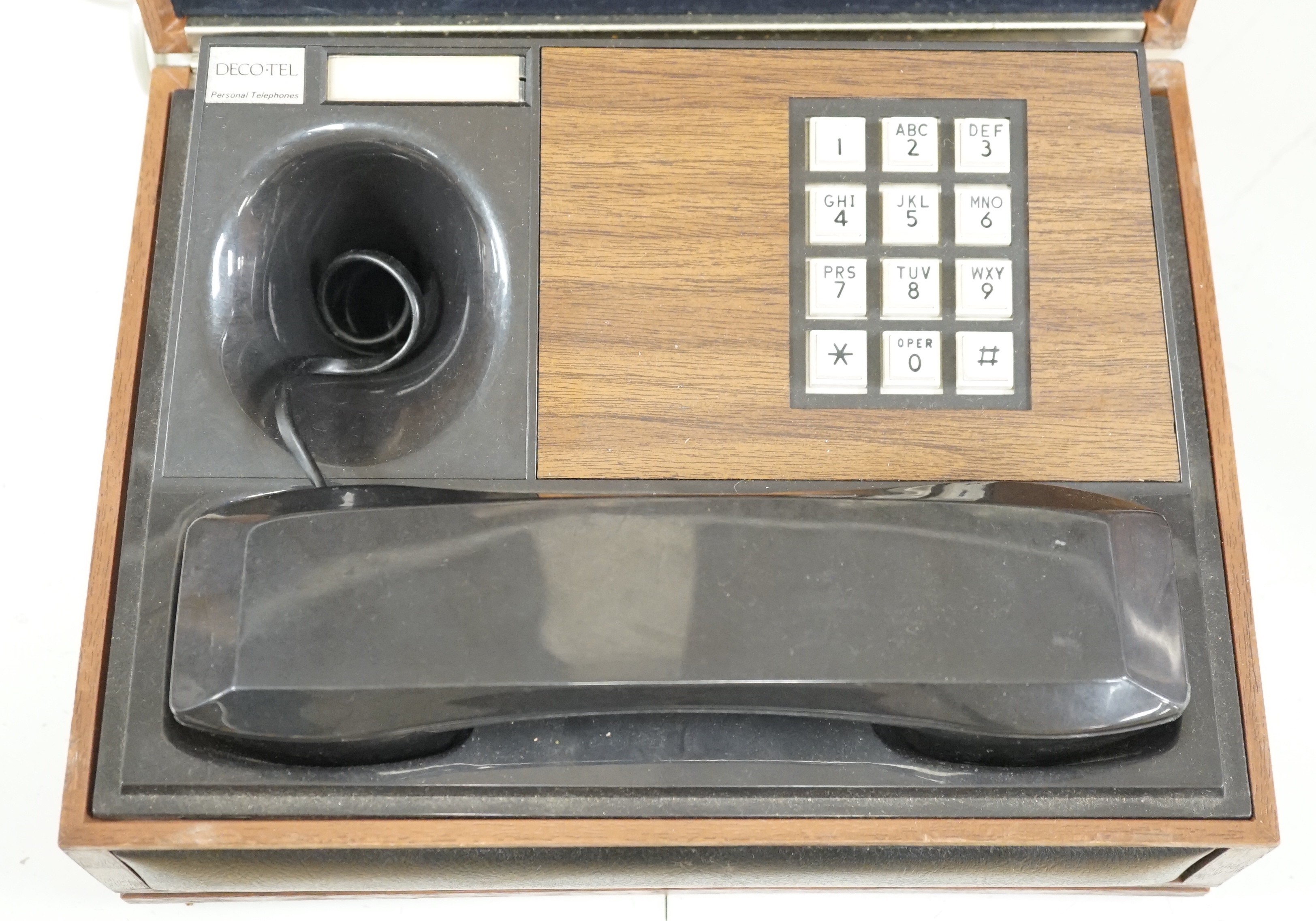 A Deco-Tel personal telephone set in hinged case