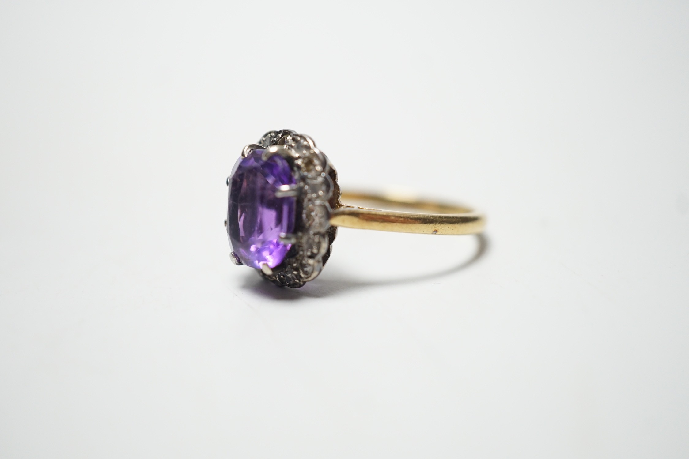 An 18ct, amethyst and diamond set oval cluster ring, size P, gross weight 4.5 grams. - Image 2 of 4