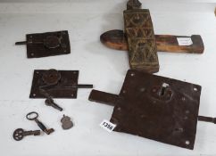 Three early ironwork lock plates with keys and a carved hardwood bolting lock