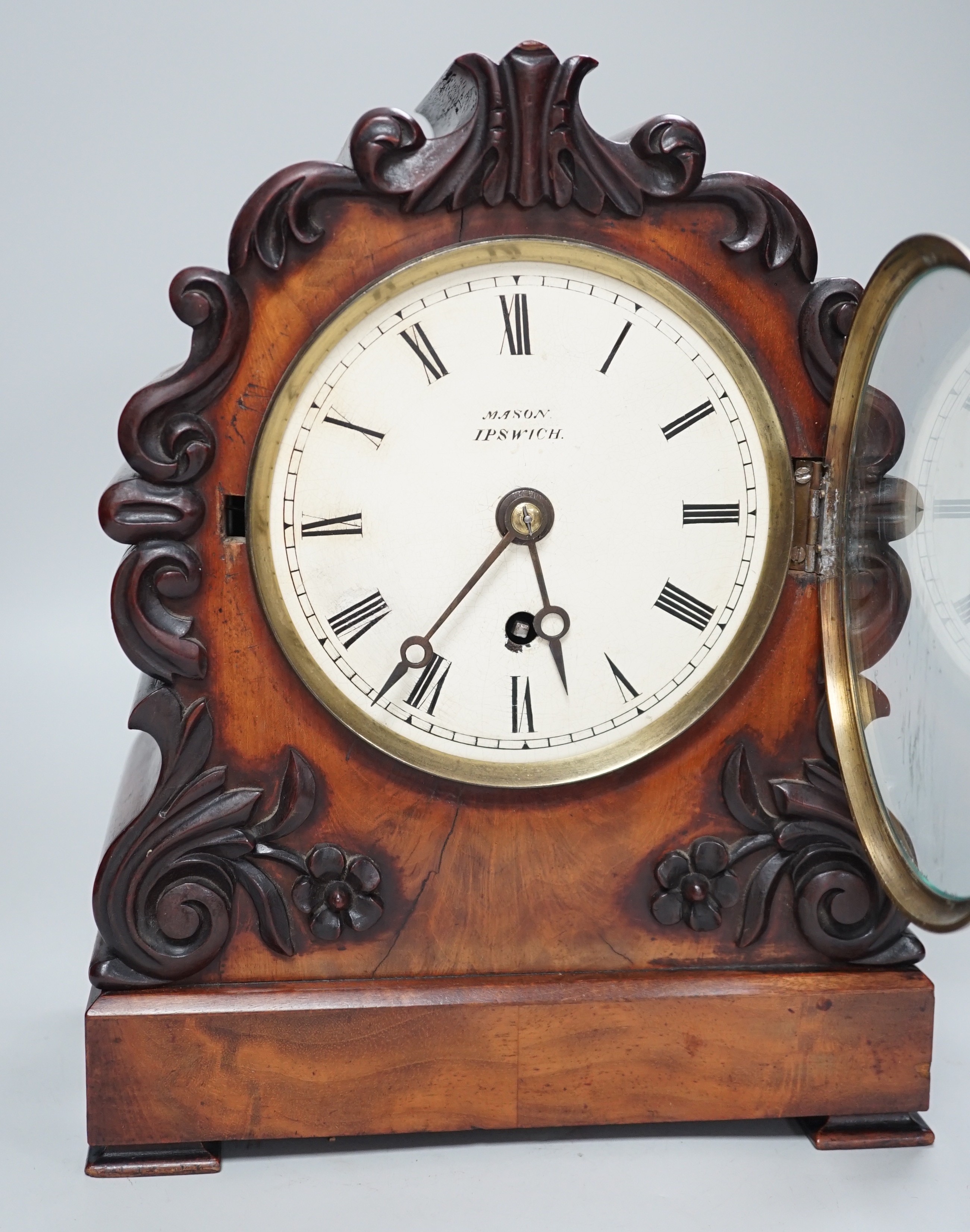 Mason, Ipswich. A 19th century mahogany cased mantel clock with scrolling moulded decoration -