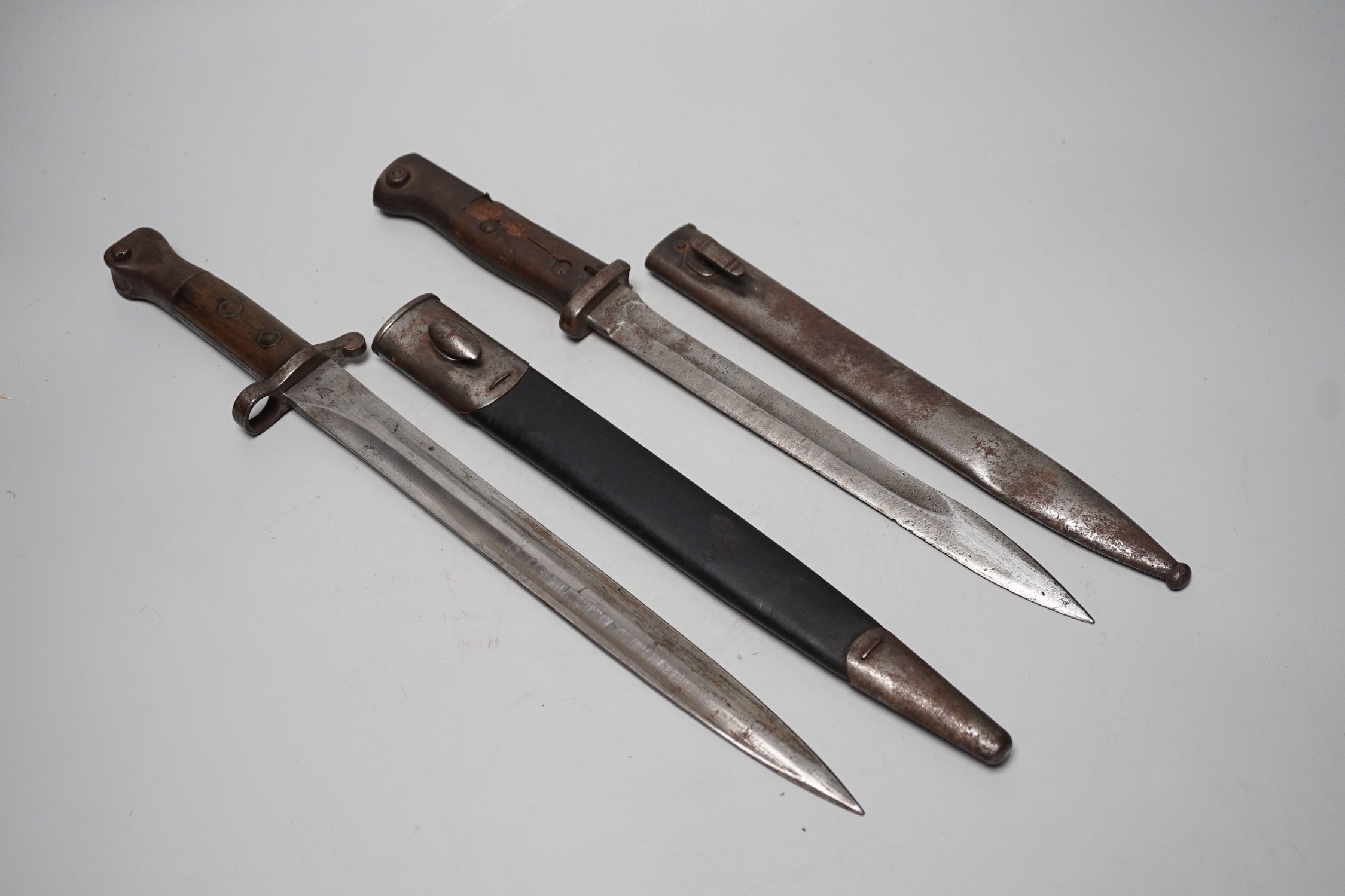 A 19th century British bayonet and scabbard together with a German bayonet and scabbard, the blade