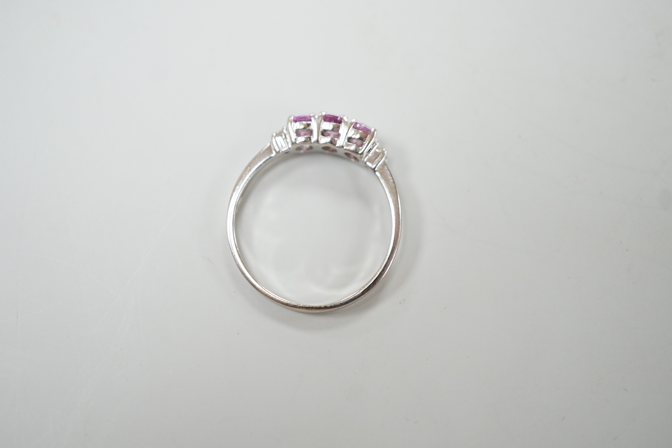 A modern 14ct white gold, three stone pink sapphire and two stone diamond chip set ring, size L, - Image 4 of 4