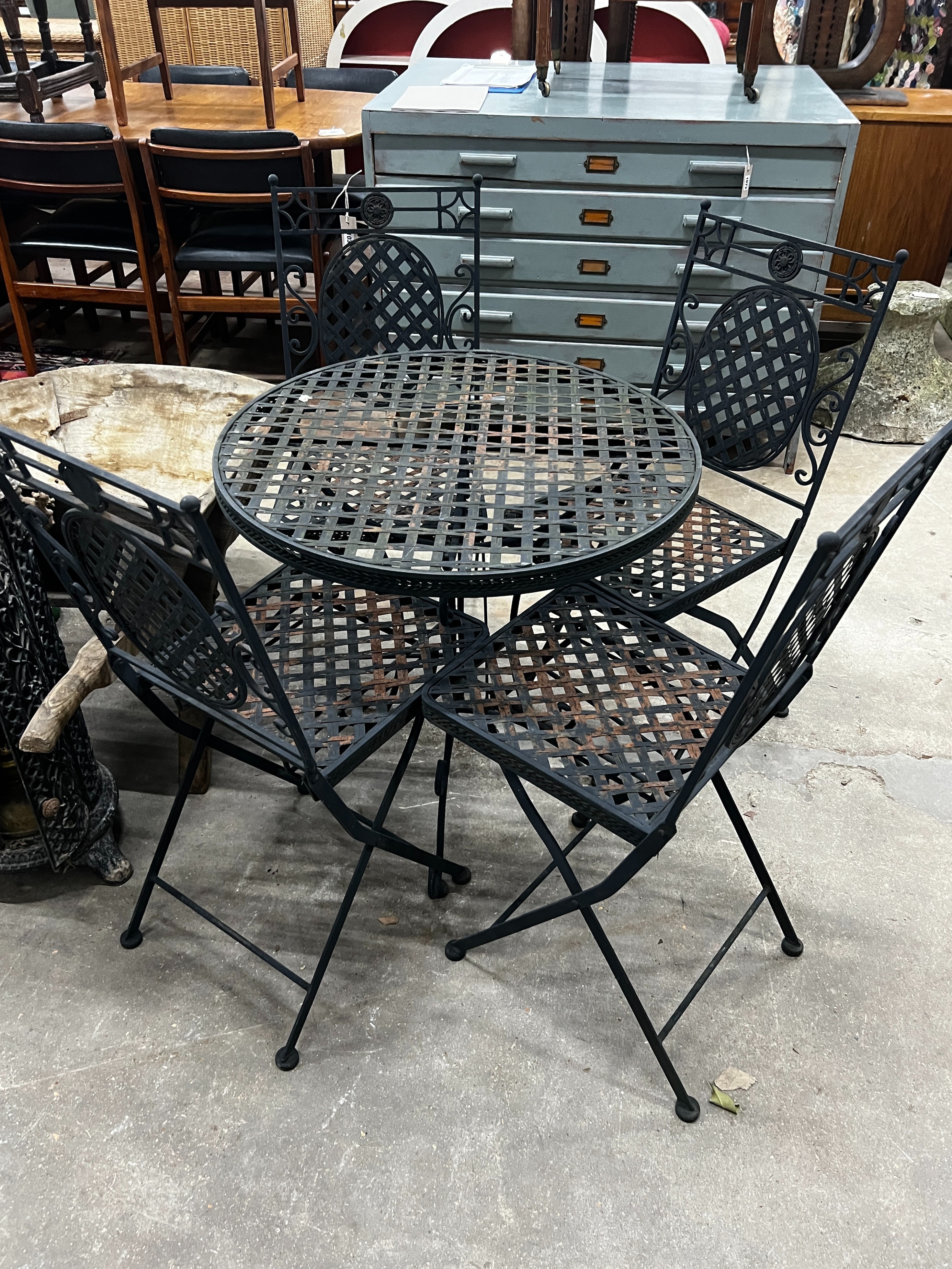 A circular painted metal garden table, diameter 70cm, height 71cm together with four matching