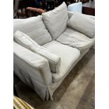 An Oka two seater settee upholstered in a natural linen fabric, length 1080, depth 98cm, height