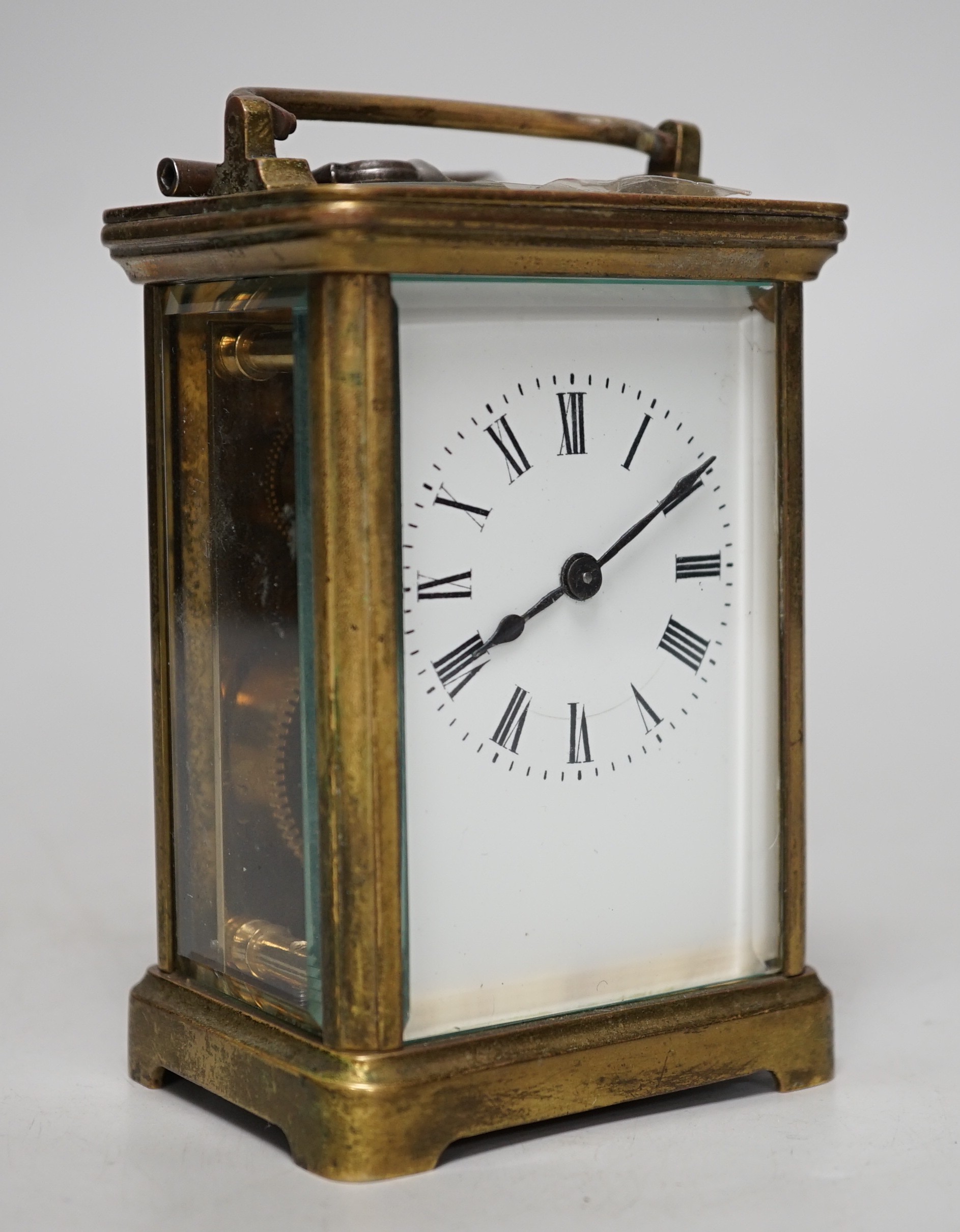 A 19th century brass carriage timepiece with black Roman numerals and second markers over a white