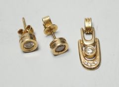 A modern pair of 585yellow metal and solitaire diamond set ear studs, 6mm and a matching pendant,