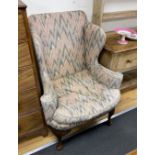 A George III style upholstered wing armchair, width 84cm, depth 75cm, height 112cm