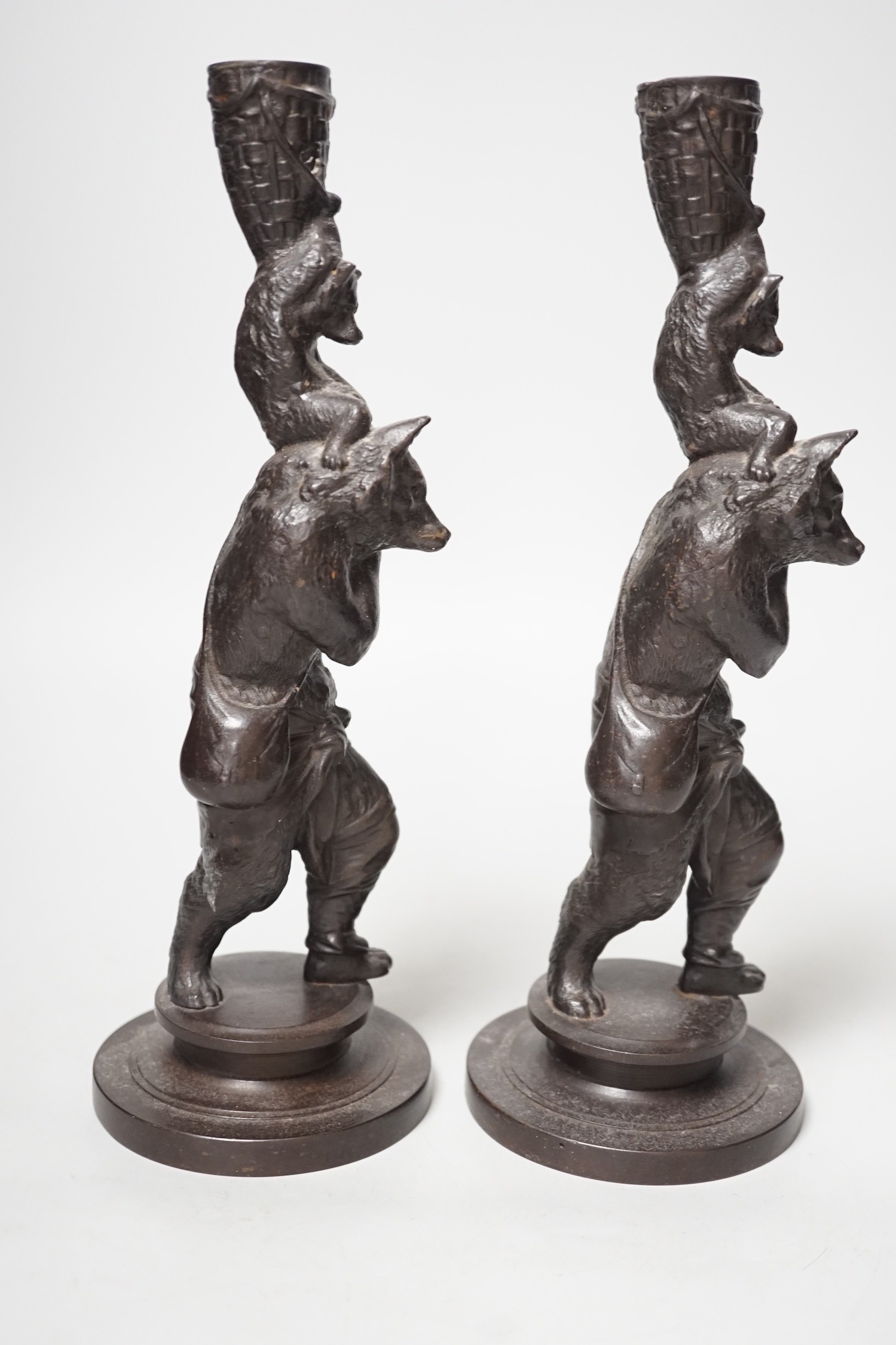 A pair of cast iron candlesticks in the form of anthropomorphised foxes and cubs. 27cm tall - Image 2 of 3