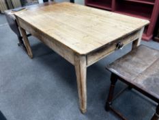 A Victorian rectangular pine kitchen table with planked top and single frieze drawer, length