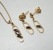 A modern 585 yellow metal and three stone sapphire set pendant necklace, overall 46cm necklace and a