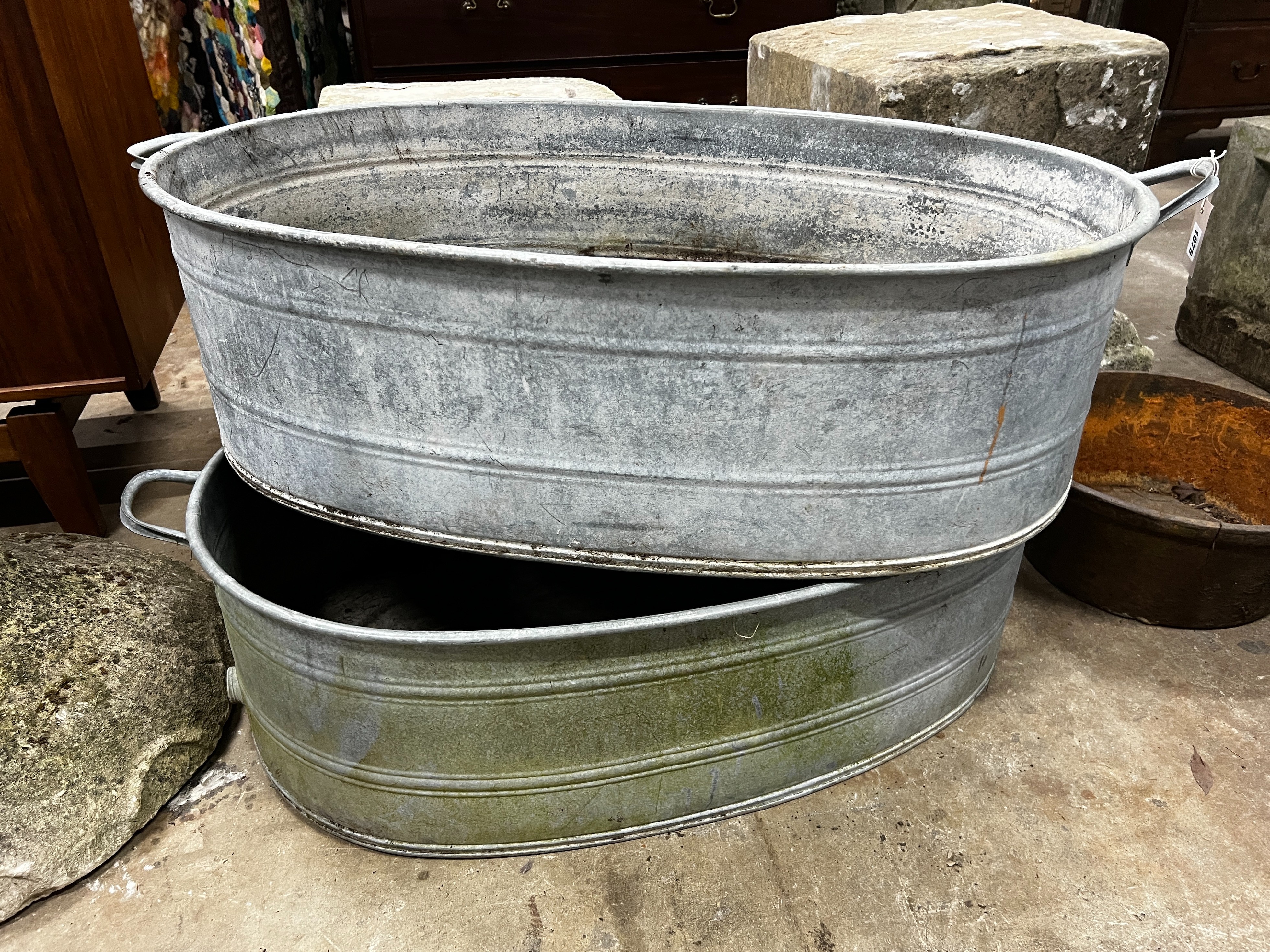 A pair of oval vintage galvanised zinc water troughs, length 104cm, depth 58cm, height 28cm together