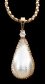 A 15ct gold mounted pear shaped baroque pearl and diamond set pendant, on an associated Italian 9k