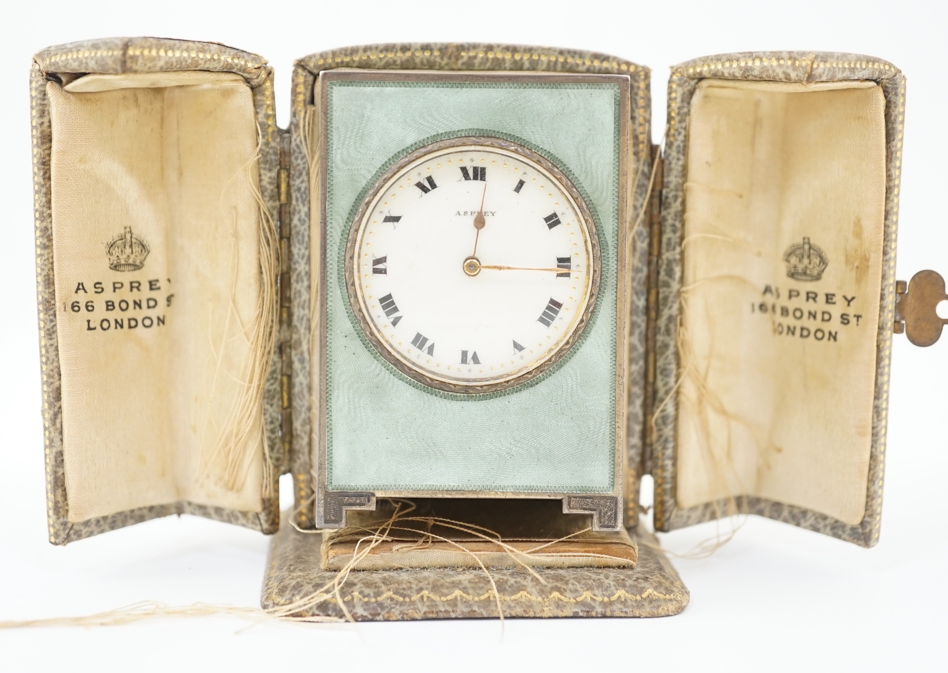 A George V silver and green guilloche enamelled travelling timepiece, retailed by Asprey, in - Image 11 of 11