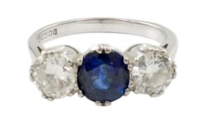 A modern 18ct white gold, single stone oval cut sapphire and two stone round cut diamond set ring,