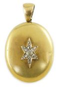 A Victorian gold and rose cut diamond set oval pendant locket, the front panel with central star