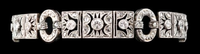 A 1920's pierced 18ct white gold and millegrain set round and rose cut diamond cluster bracelet,