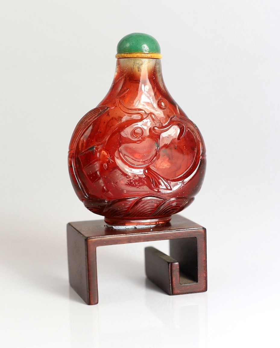 A Chinese ruby red glass ‘leaping carp’ snuff bottle, 1750-1850, each side carved in high relief - Image 2 of 6