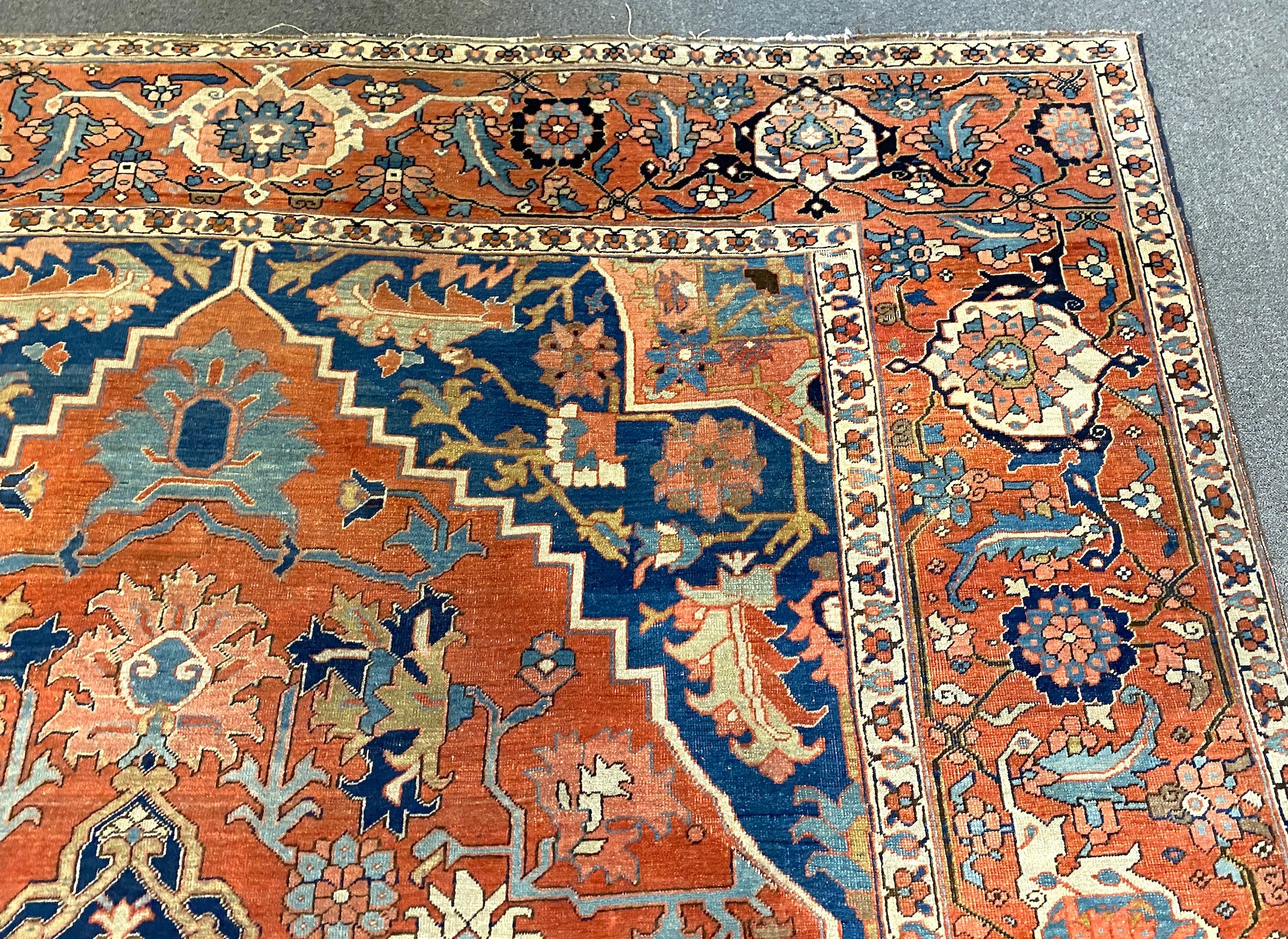 An antique Heriz brick red ground carpet, with large central floral medallion within a wide - Image 5 of 7