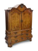 An 18th century Dutch walnut armoire, with scroll moulded cornice and two panelled doors enclosing