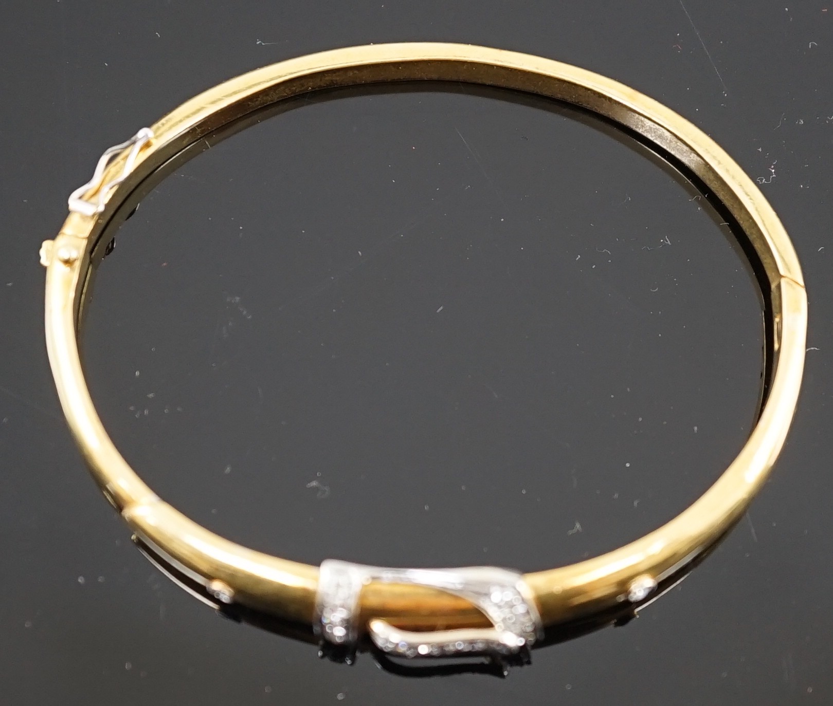 A gold and diamond set hinged bangle with central buckle motif, interior diameter 58mm, gross weight - Image 3 of 3