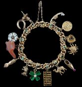 An Edwardian 15ct gold, seed pearl and turquoise set curb link charm bracelet, the links with