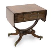 Y Y A Regency mahogany drop leaf work table, with beaded rectangular top, scroll carved folding