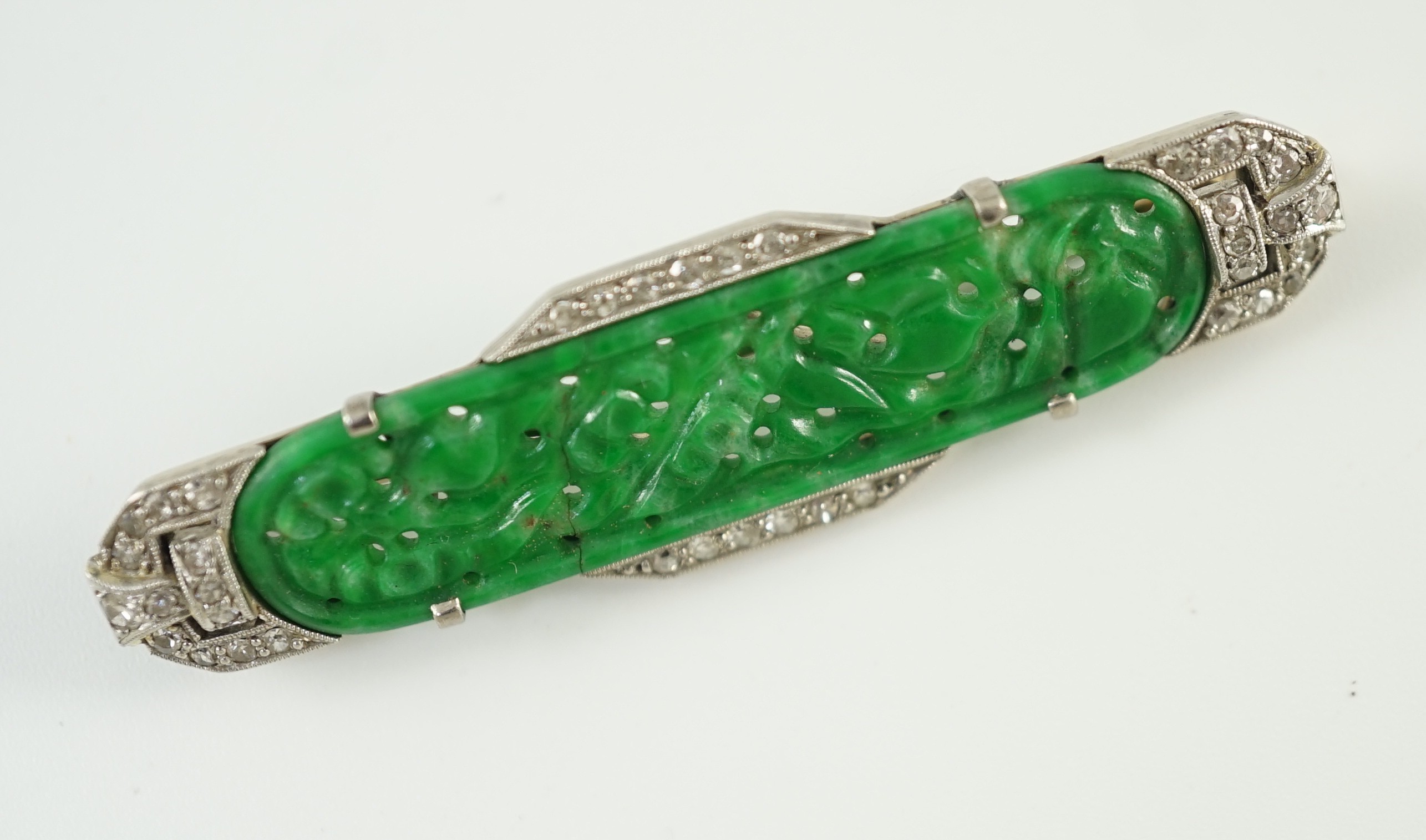 An Art Deco white gold, jadeite and diamond set bar brooch, the jadeite with carved foliate - Image 3 of 3