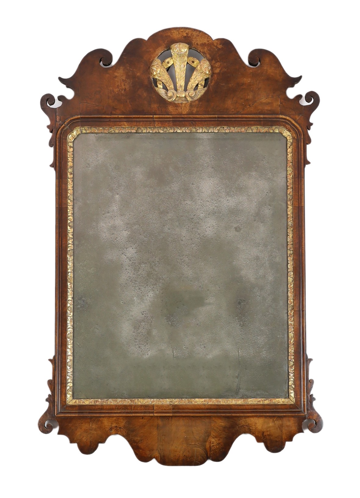 A George II walnut and parcel gilt fret frame wall mirror, with Prince of Wales feathered crest