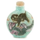 A Chinese enamelled porcelain ‘mythical beasts’ snuff bottle, 1850-1900, painted with a tiger, two