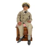 A Leonard Insull ventriloquist's dummy, dressed in a check suit and wearing a sailor's cap,