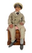 A Leonard Insull ventriloquist's dummy, dressed in a check suit and wearing a sailor's cap,