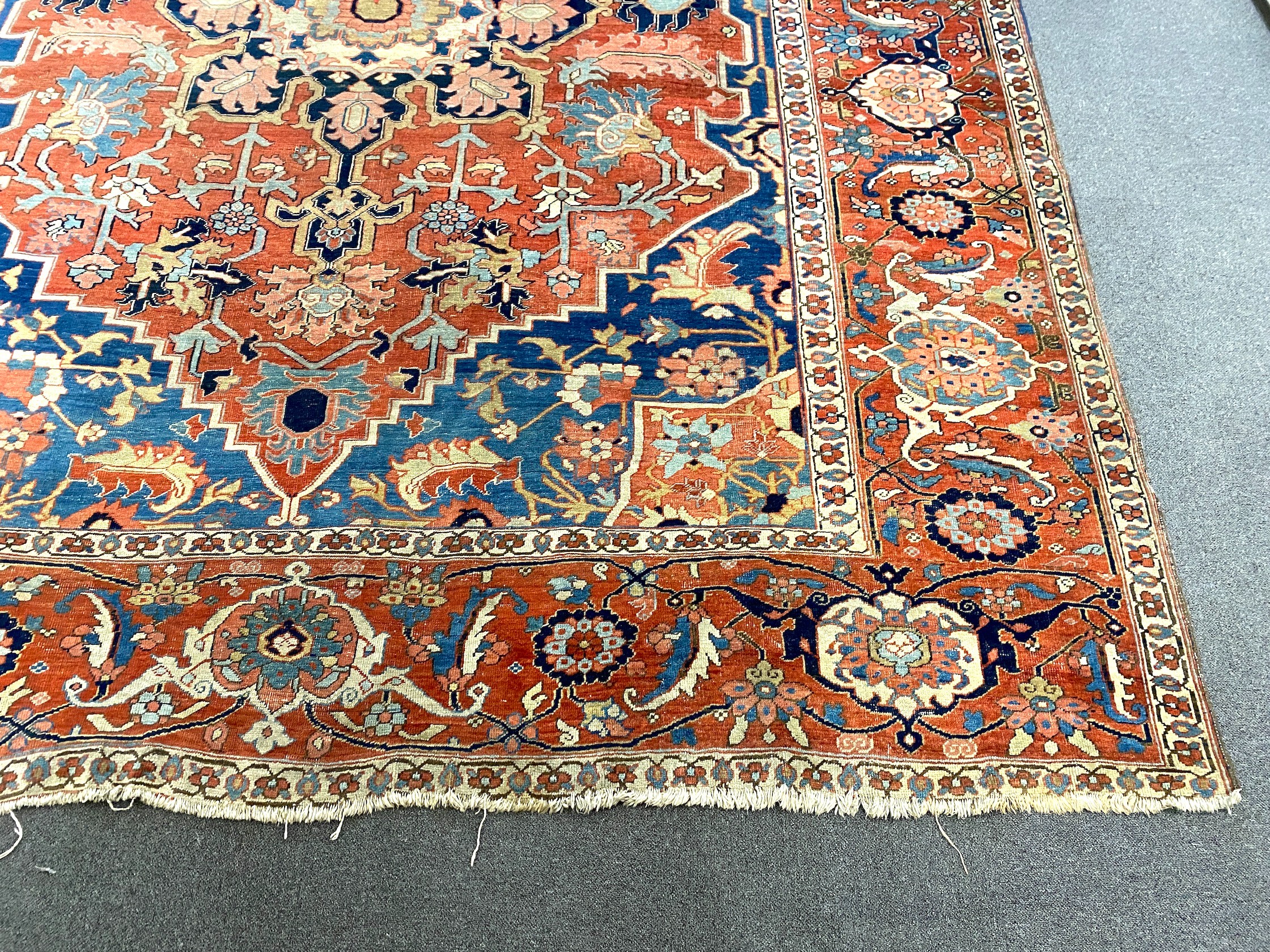 An antique Heriz brick red ground carpet, with large central floral medallion within a wide - Image 2 of 7