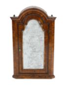 A Queen Anne walnut hanging corner cupboard, with arched cornice and single arched door above a
