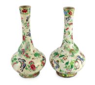 A pair of Chinese enamelled porcelain crackle glaze bottle vases, mid 19th century, each painted