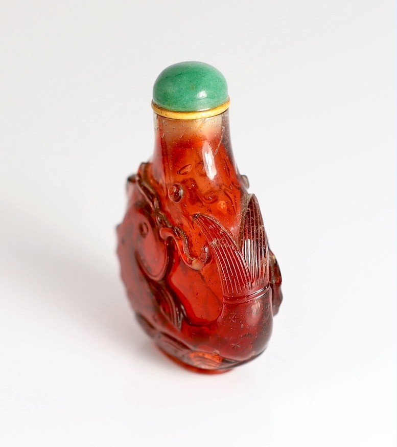 A Chinese ruby red glass ‘leaping carp’ snuff bottle, 1750-1850, each side carved in high relief - Image 4 of 6