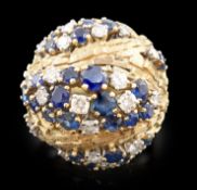 A late 20th century textured 18ct gold, sapphire and diamond cluster set domed dress ring, by E.