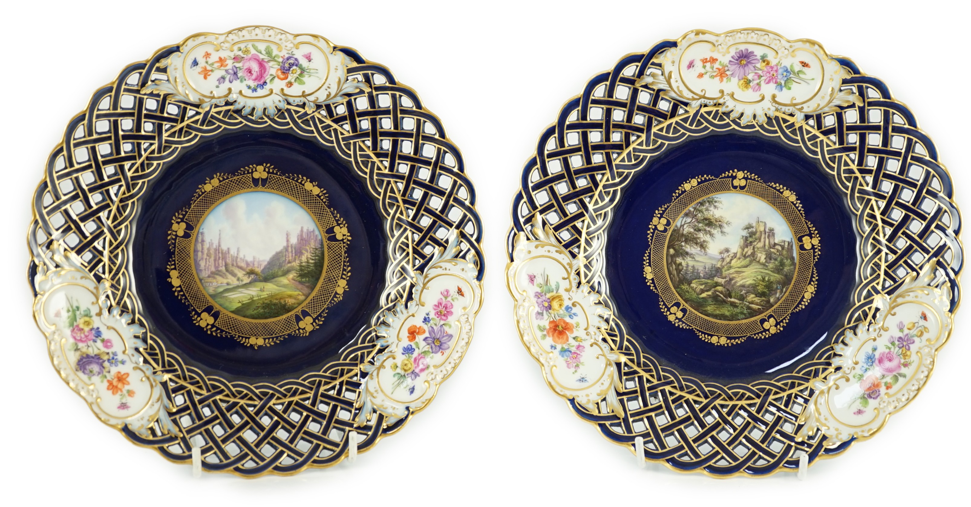 A pair of Meissen reticulated named view plates, 19th century, painted to the centre with named